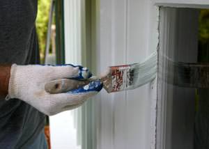 Putting on a second coating of paint on a Woodbridge, Seymour home